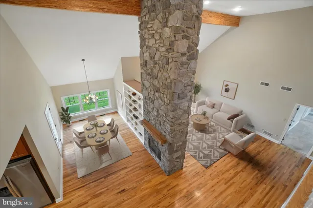 a view of empty room with wooden floor and window