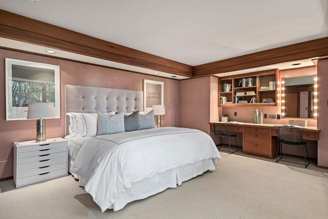 a bedroom with a large bed and a window