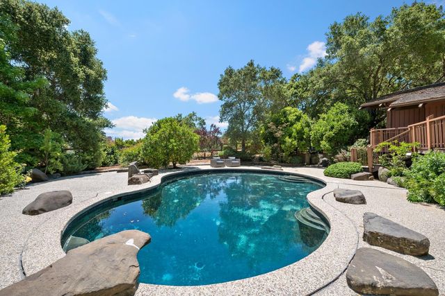 a view of a swimming pool with a yard