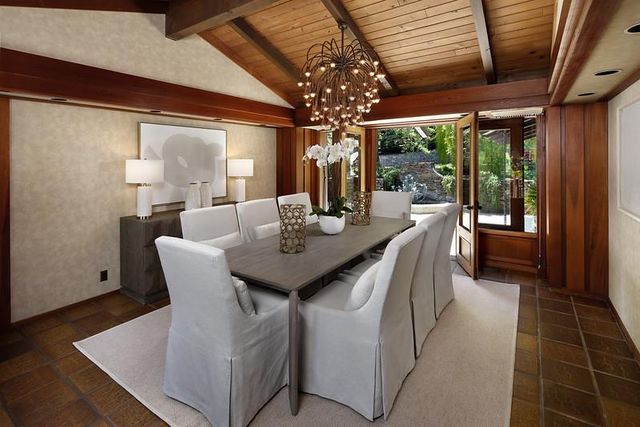 a dining room with furniture and a chandelier