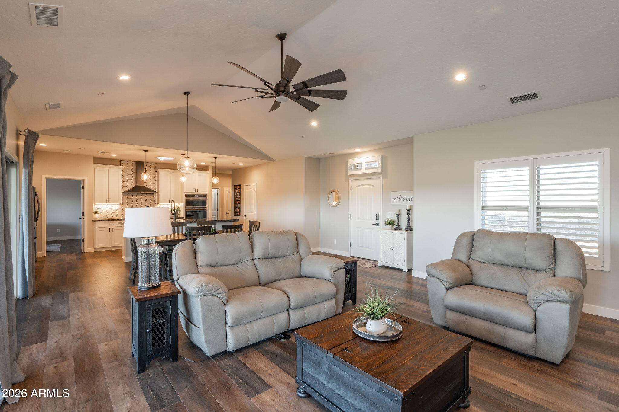 15140 East Countryside Road Mayer, AZ 86333 - Photo 11 of 67 a living room with furniture a wooden floor and a chandelier