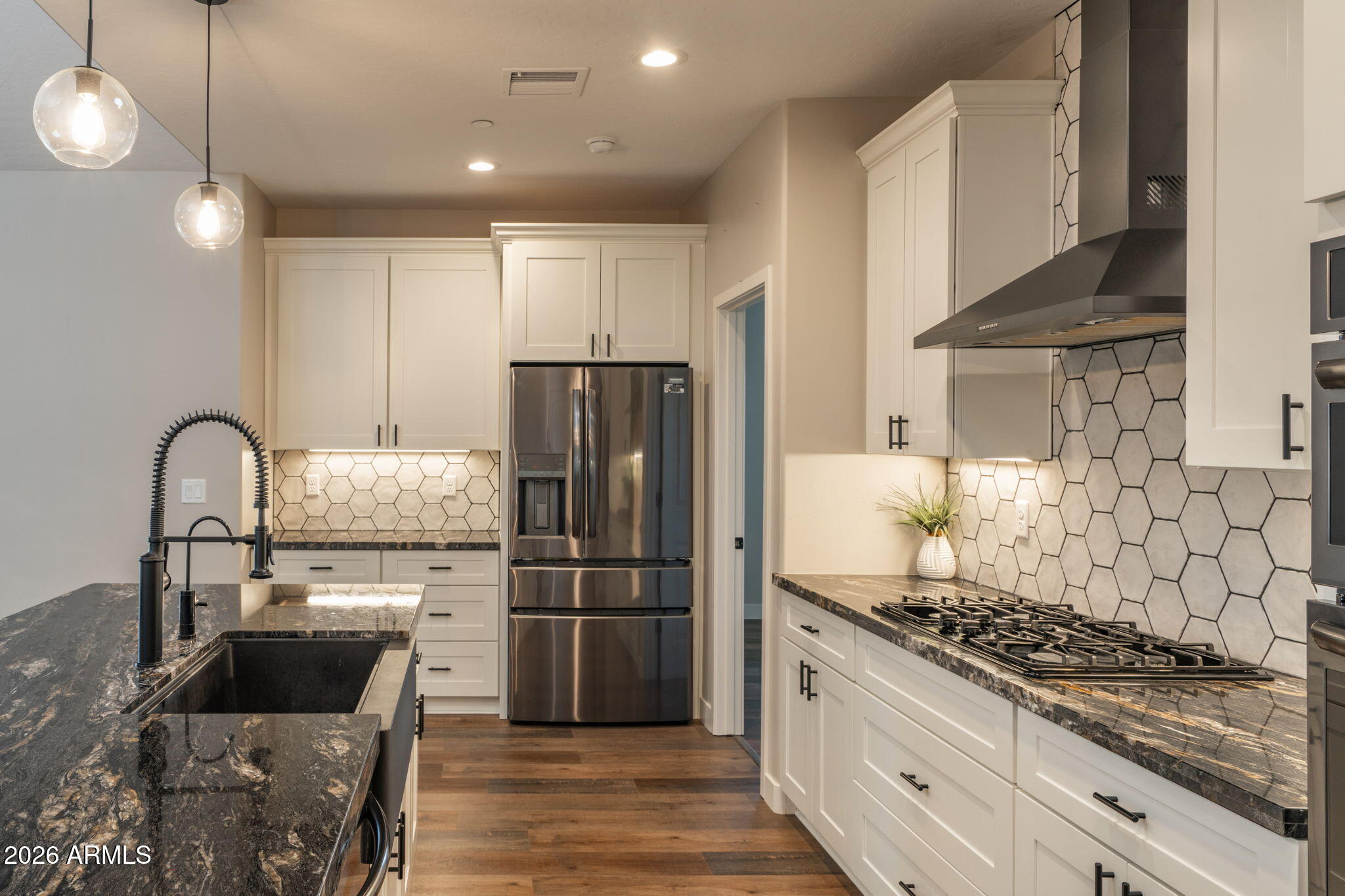15140 East Countryside Road Mayer, AZ 86333 - Photo 16 of 67 a kitchen with a stove and a refrigerator