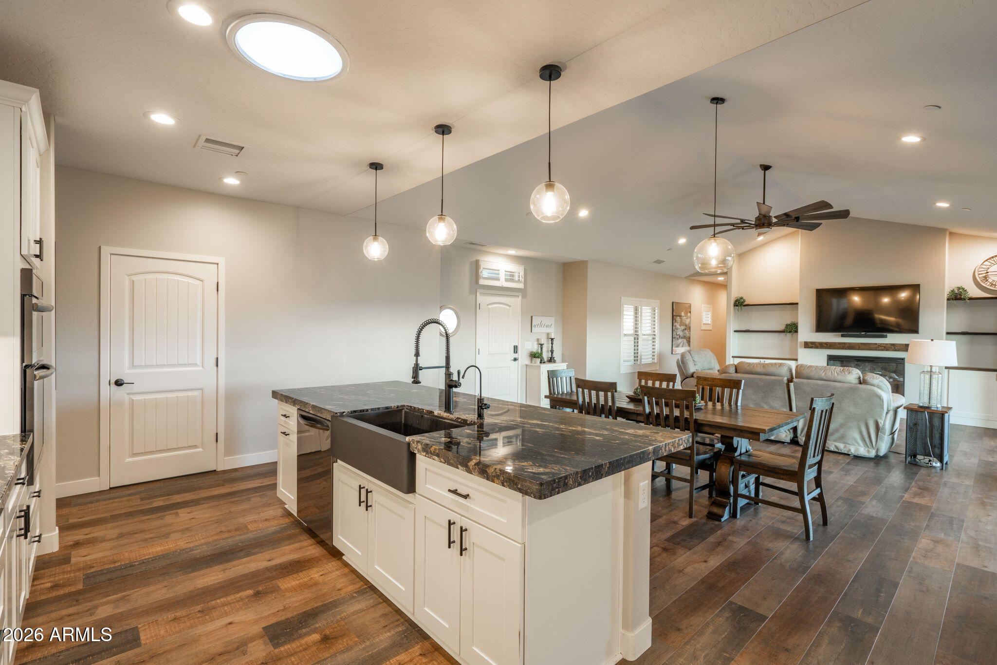 15140 East Countryside Road Mayer, AZ 86333 - Photo 17 of 67 a kitchen with stainless steel appliances granite countertop a sink a stove and a wooden floors