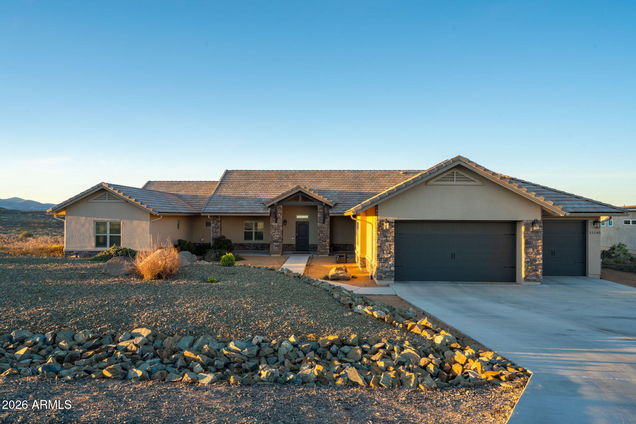 15140 East Countryside Road Mayer, AZ 86333 - Photo 2 of 67 a front view of a house with garden