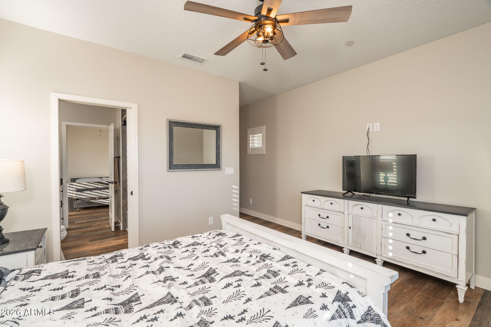 15140 East Countryside Road Mayer, AZ 86333 - Photo 21 of 67 a bedroom with a bed and a flat tv screen on dresser