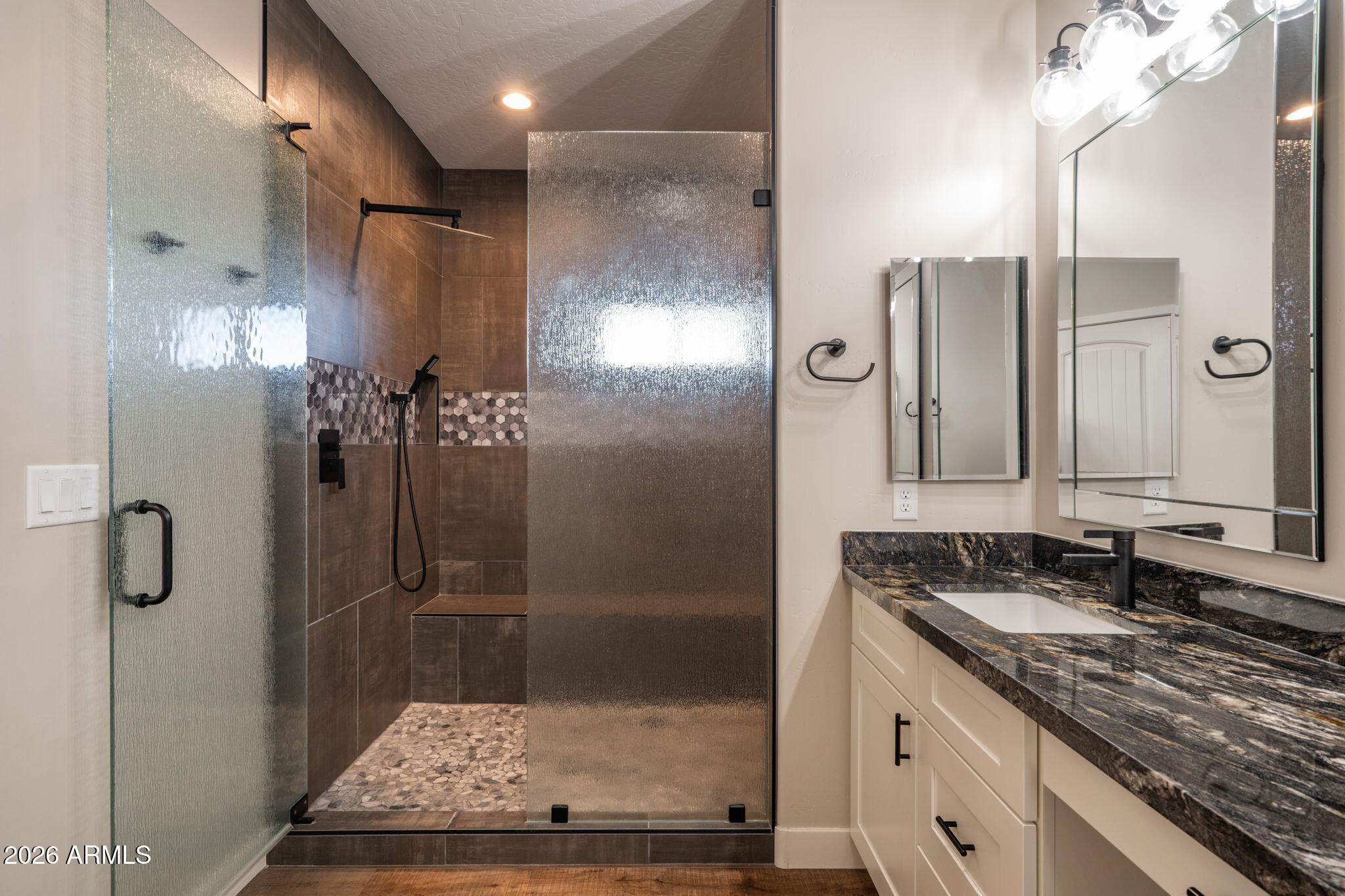 15140 East Countryside Road Mayer, AZ 86333 - Photo 22 of 67 a bathroom with a shower sink and mirror