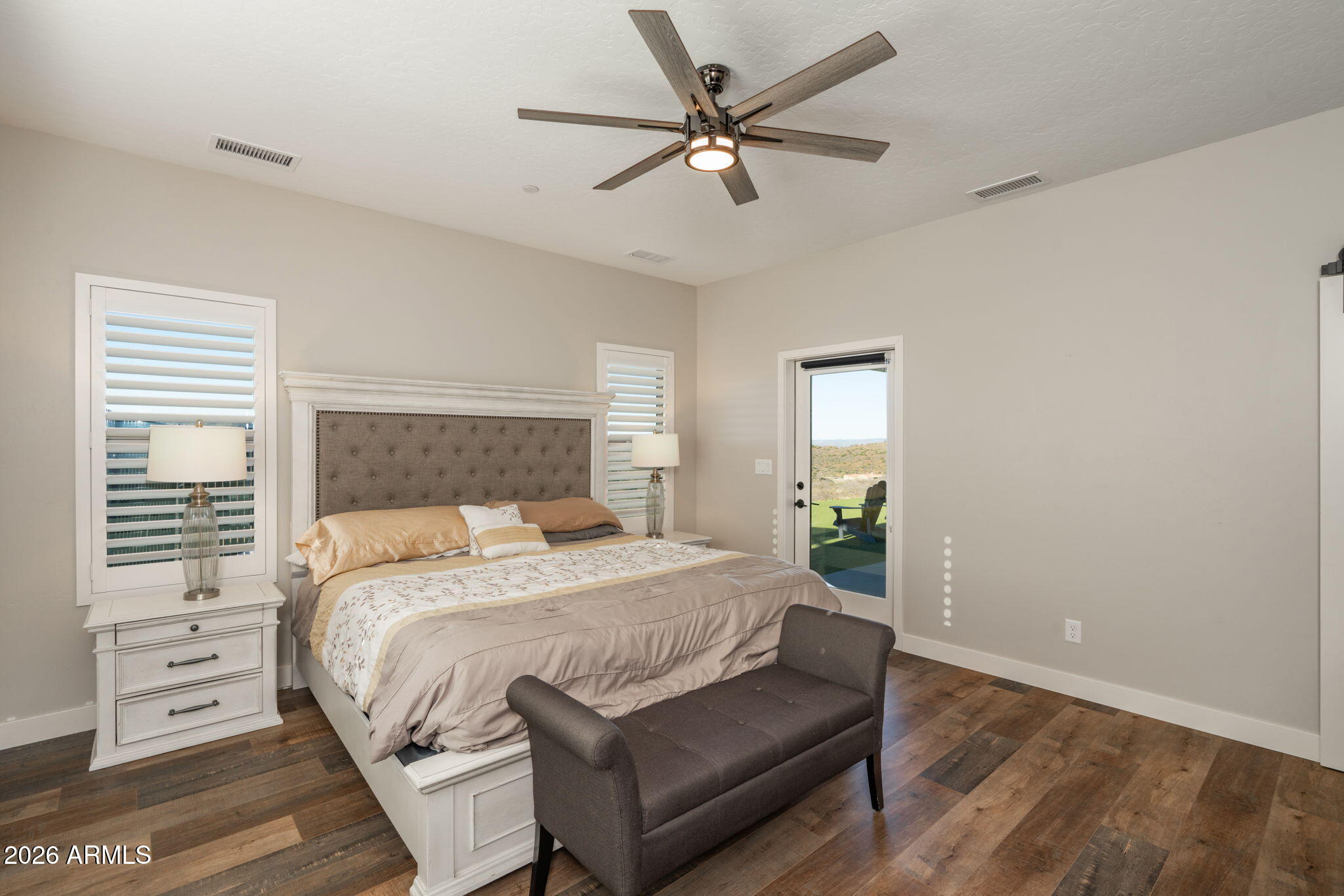 15140 East Countryside Road Mayer, AZ 86333 - Photo 28 of 67 a bedroom with a large bed and a window