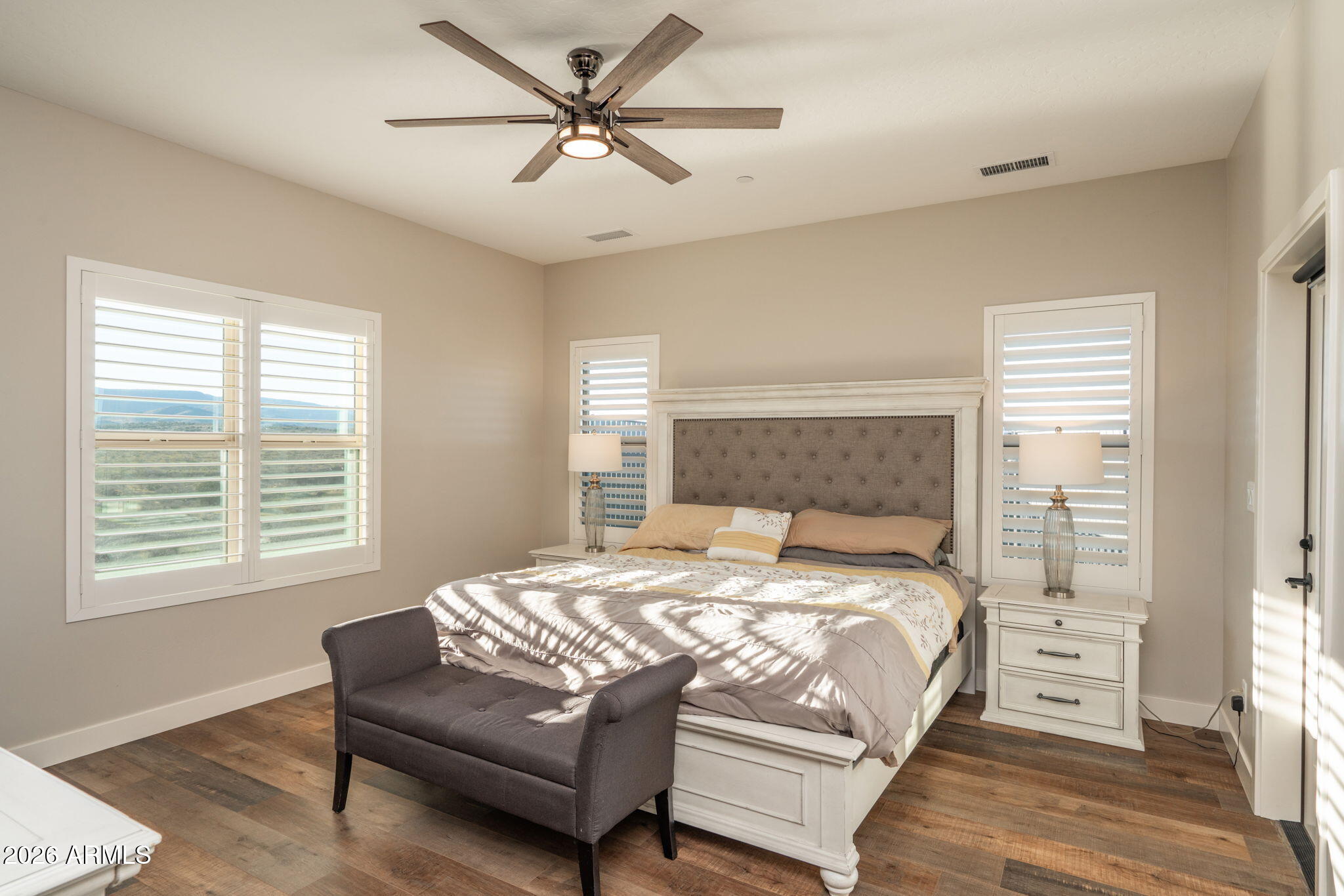 15140 East Countryside Road Mayer, AZ 86333 - Photo 29 of 67 a bedroom with a bed a couch and a window