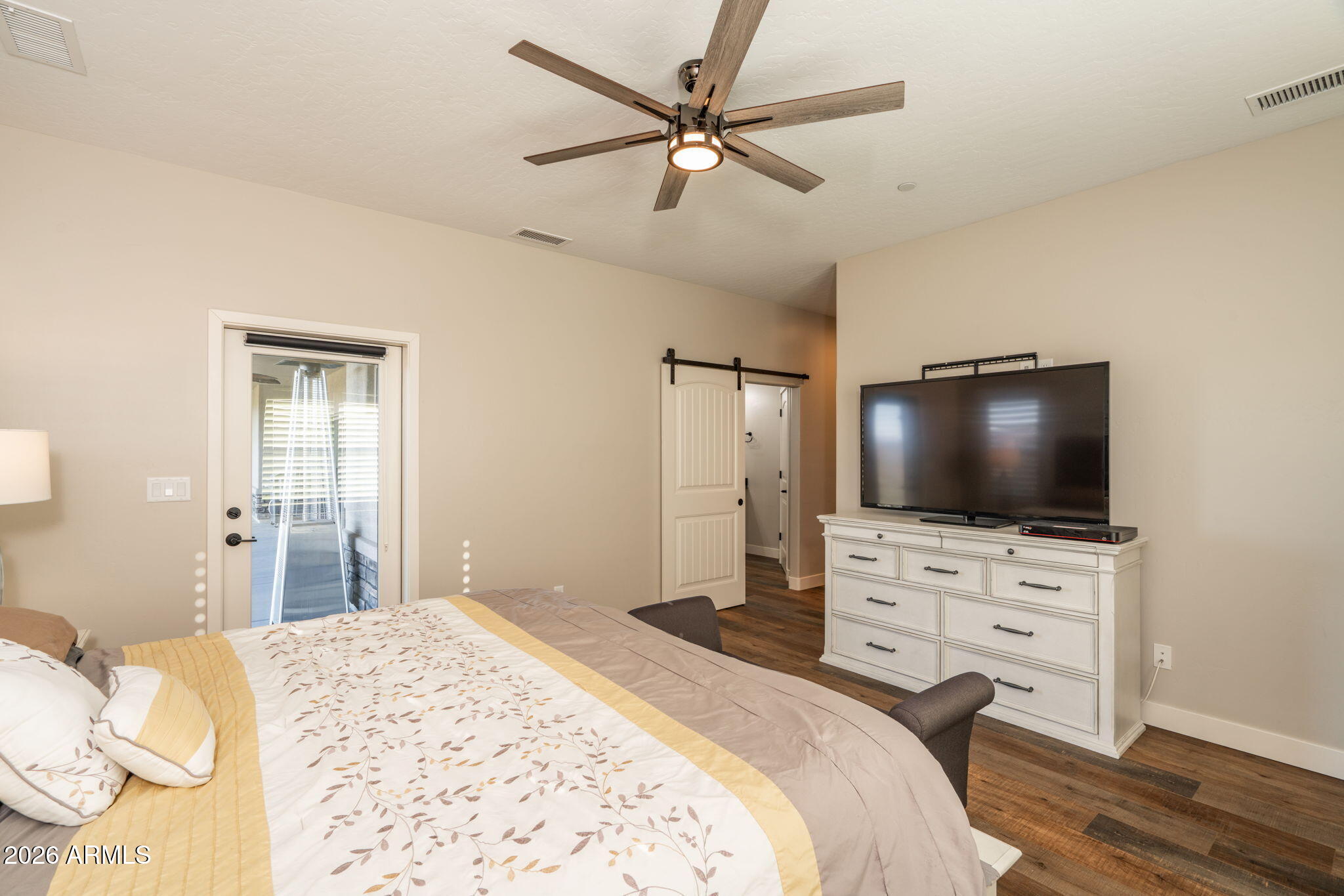 15140 East Countryside Road Mayer, AZ 86333 - Photo 30 of 67 a bedroom with a bed and a flat screen tv