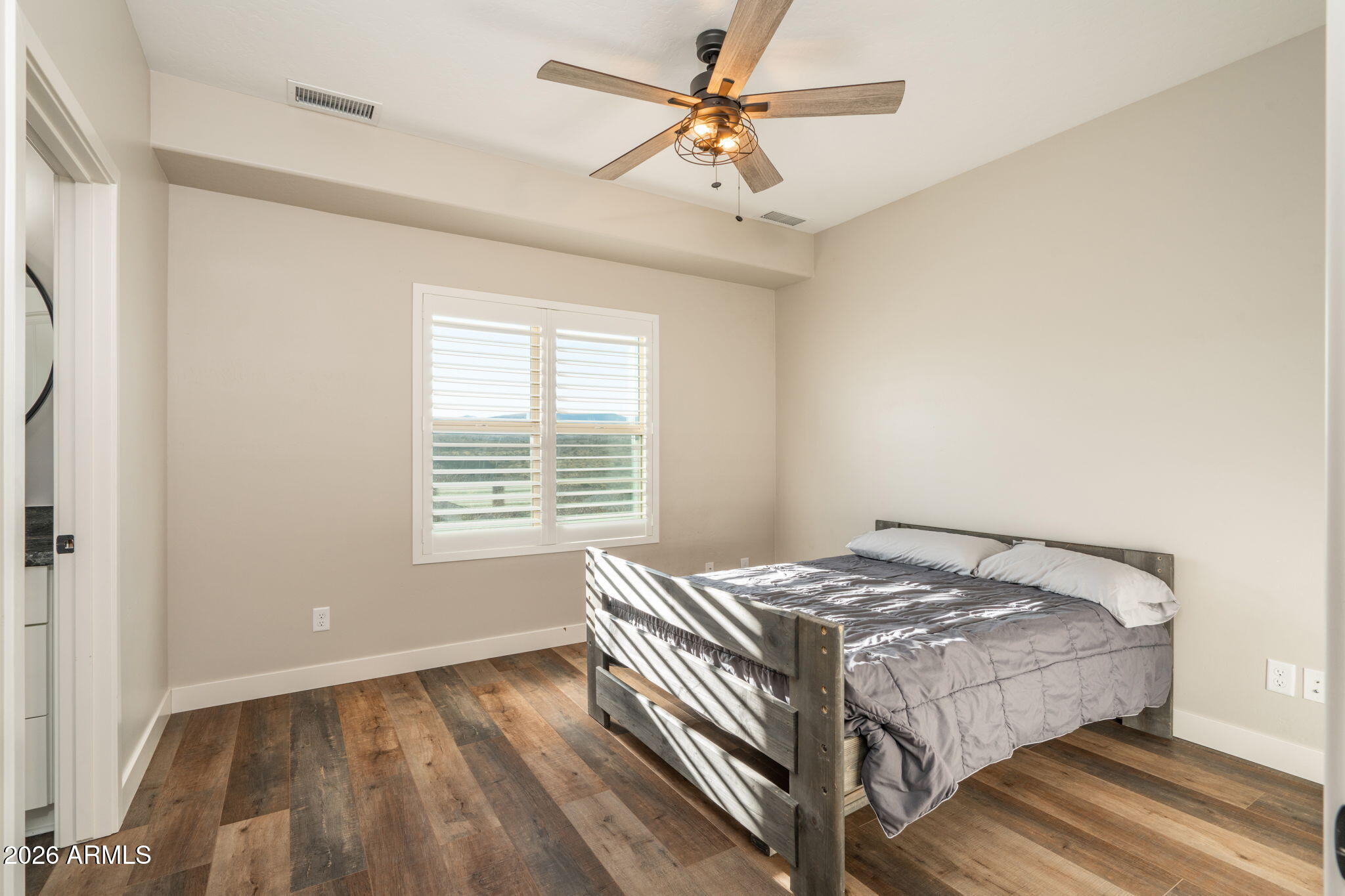 15140 East Countryside Road Mayer, AZ 86333 - Photo 36 of 67 a bedroom with a bed and a window