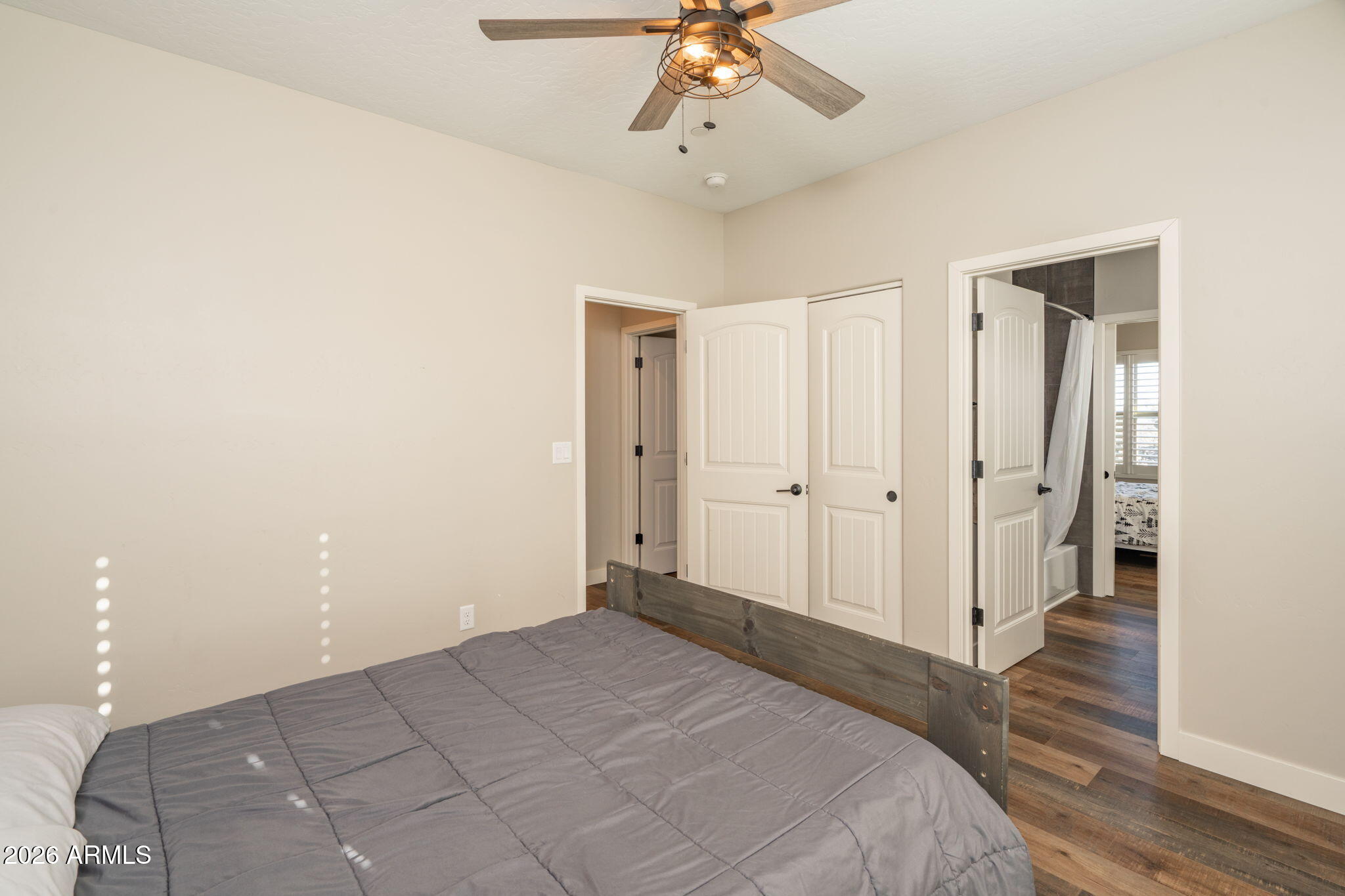 15140 East Countryside Road Mayer, AZ 86333 - Photo 37 of 67 a spacious bedroom with a bed and a chandelier