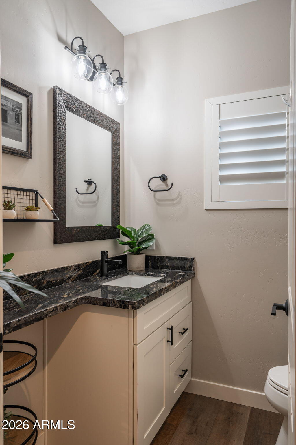 15140 East Countryside Road Mayer, AZ 86333 - Photo 39 of 67 a bathroom with a granite countertop sink a mirror and a toilet