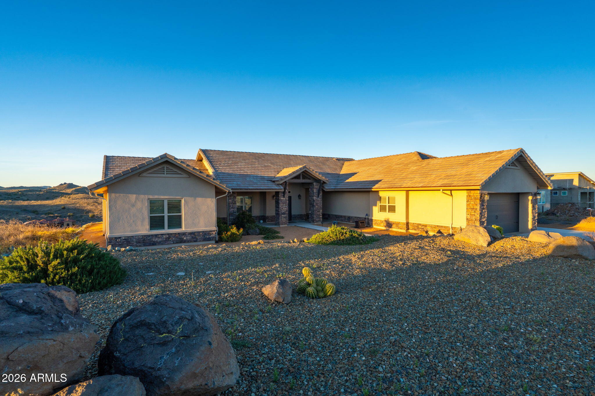 15140 East Countryside Road Mayer, AZ 86333 - Photo 4 of 67 a front view of a house with a yard and garage