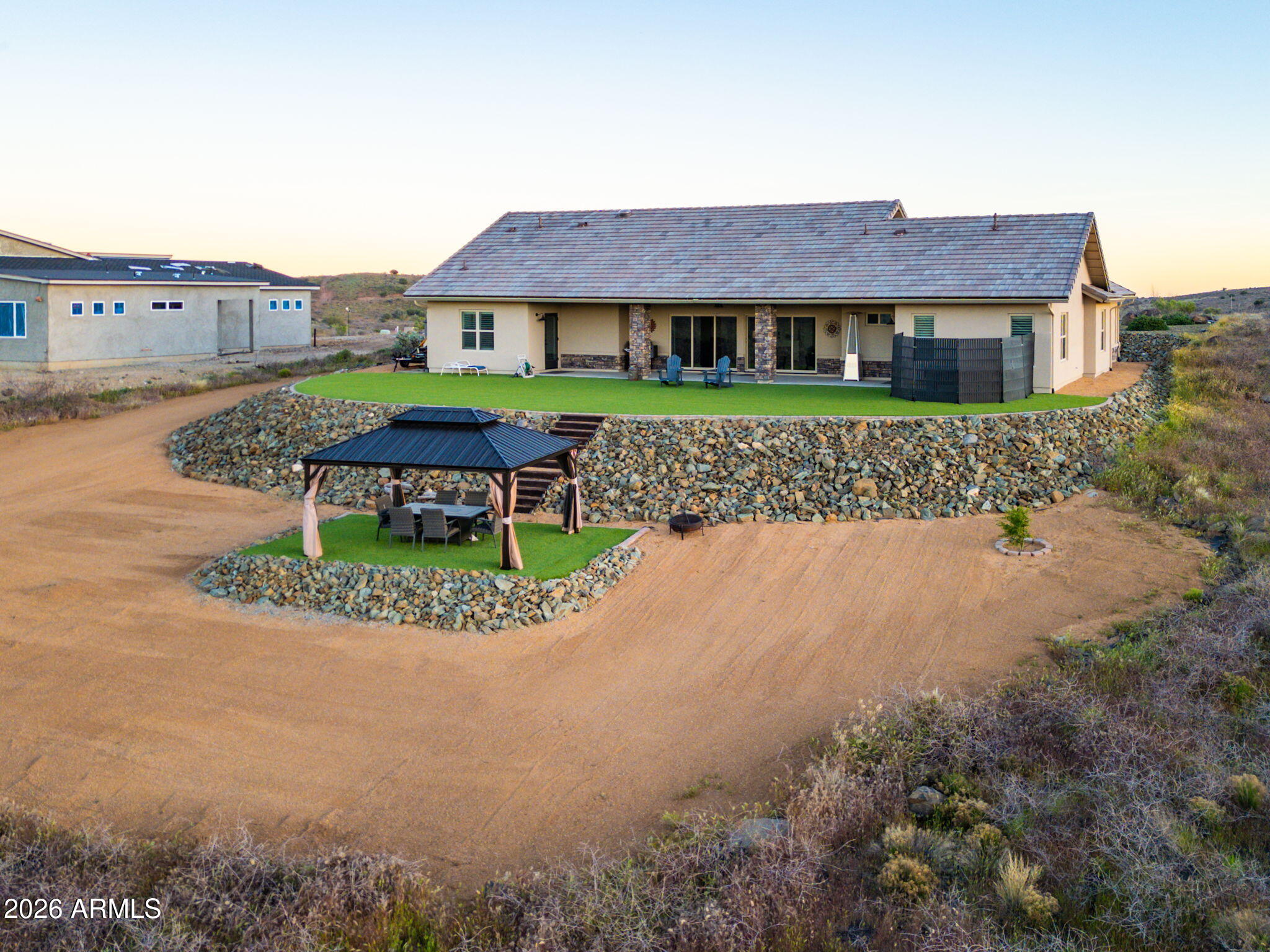 15140 East Countryside Road Mayer, AZ 86333 - Photo 45 of 67 a front view of a house with a garden and pathway