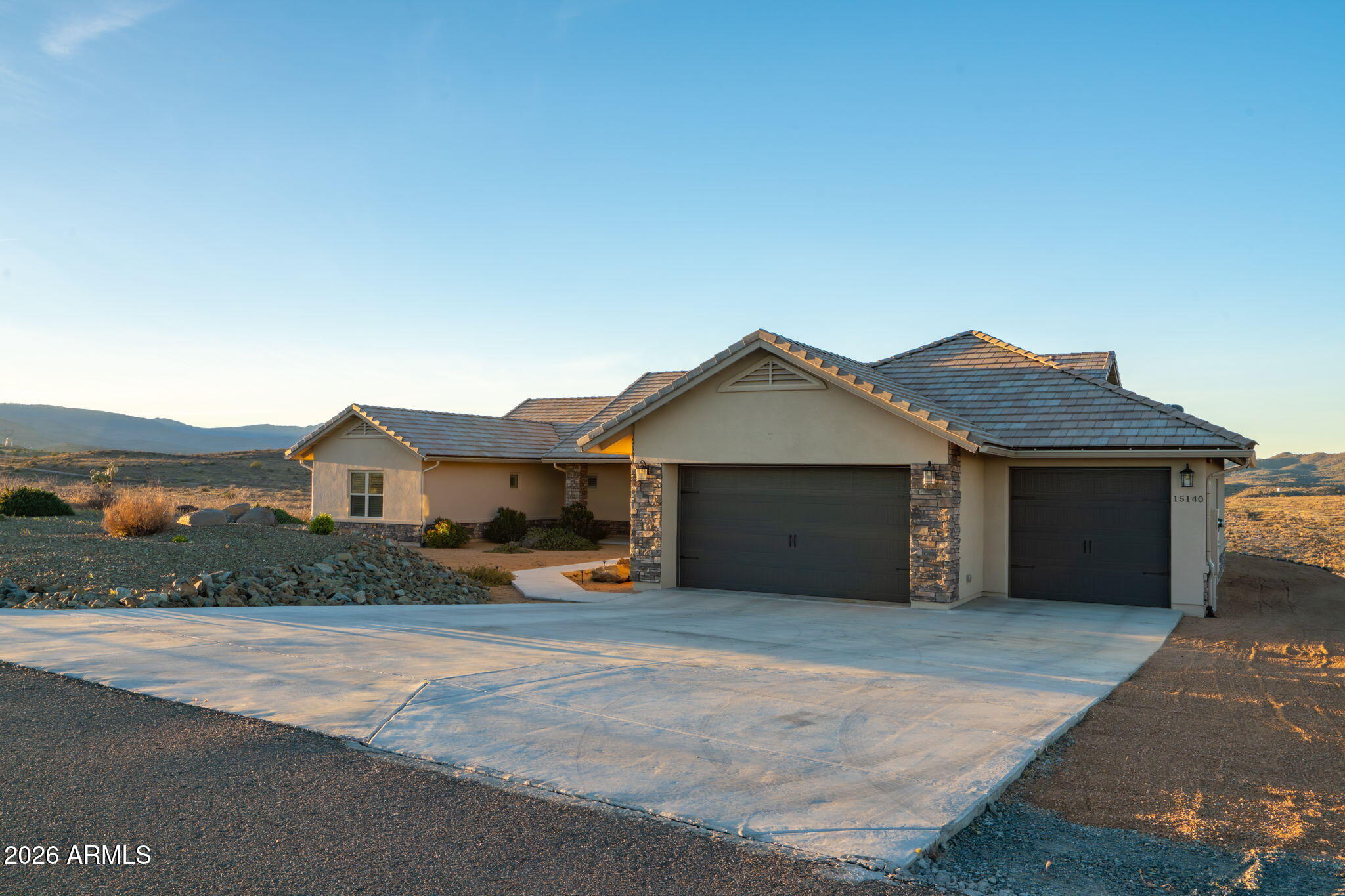 15140 East Countryside Road Mayer, AZ 86333 - Photo 5 of 67 a front view of a house with a yard and garage