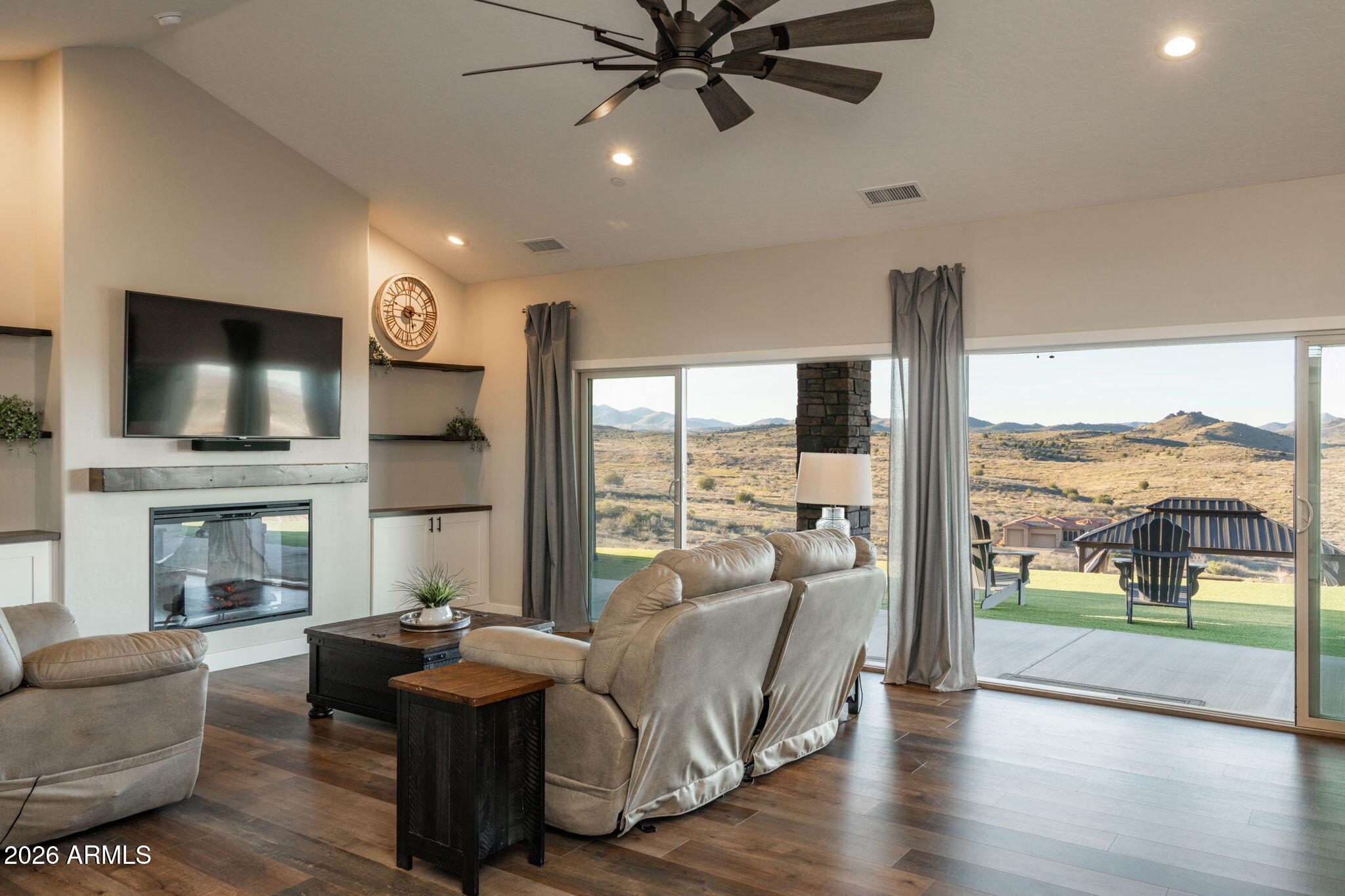 15140 East Countryside Road Mayer, AZ 86333 - Photo 8 of 67 a living room with fireplace furniture and a large window