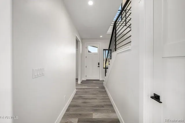 a view of an empty room with window and fire place