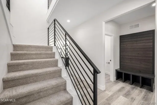 a living room with a fireplace and wooden floor