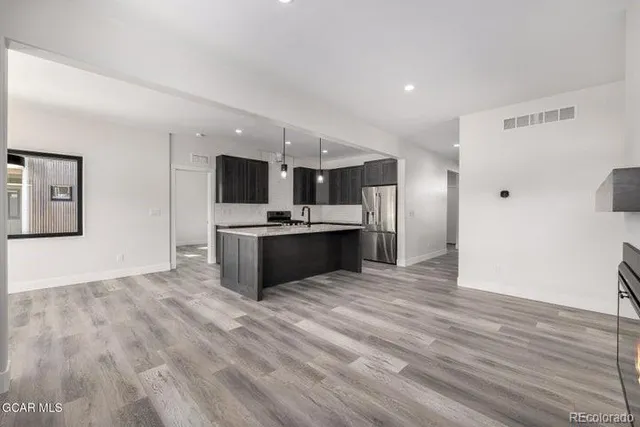 a view of a room with window wooden floor and chandelier