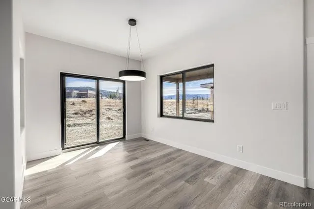 a living room with kitchen island furniture and a chandelier
