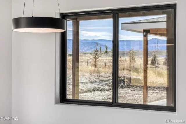 a large kitchen with stainless steel appliances a large counter top a stove and a wooden floors