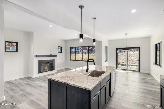 a kitchen with a refrigerator sink and stove