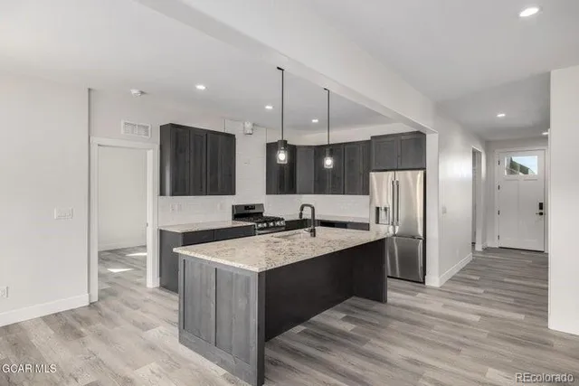a stove top oven sitting inside of a kitchen