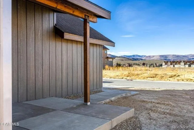 a view of a house with a patio and wooden fence