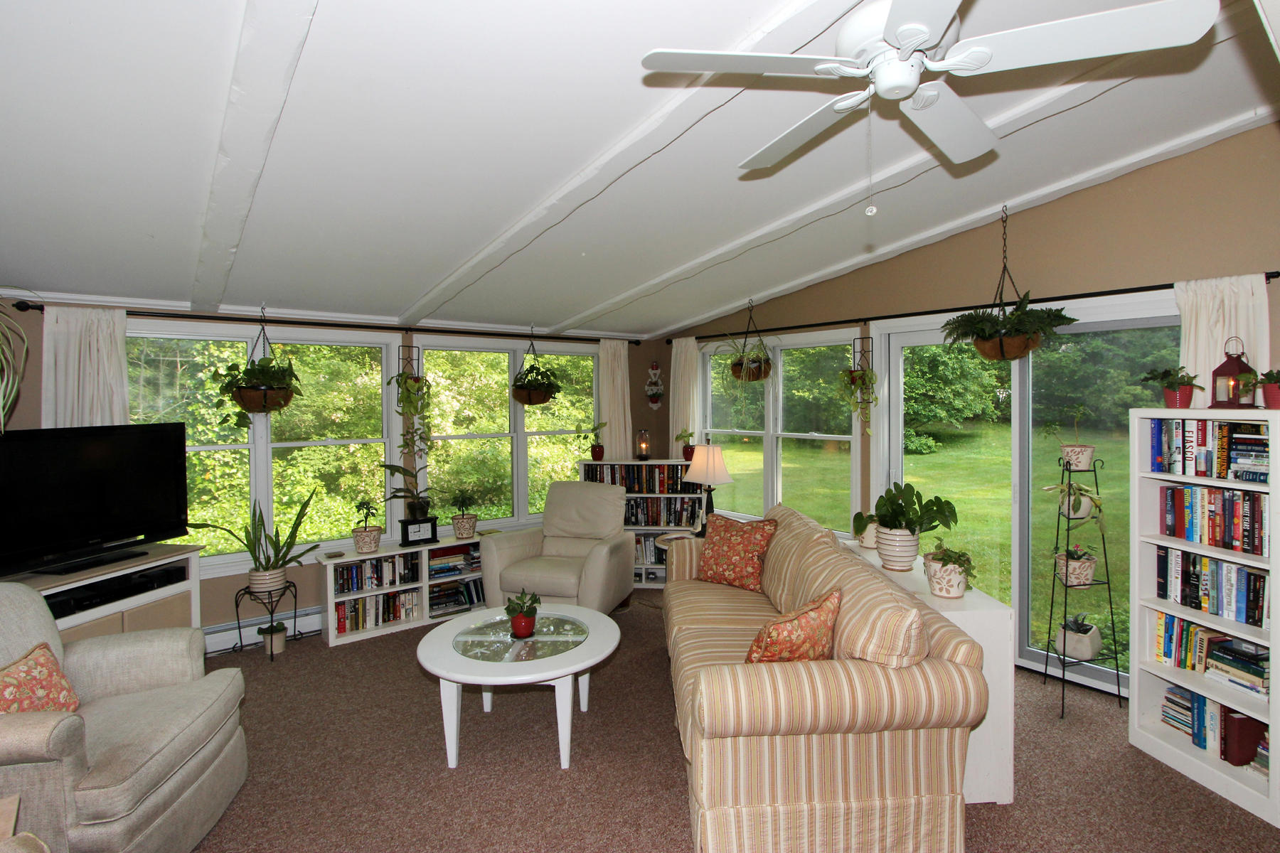 243 Midpine Road Cummaquid, MA 02675 - Photo 17 of 32 a living room with furniture a flat screen tv and a large window