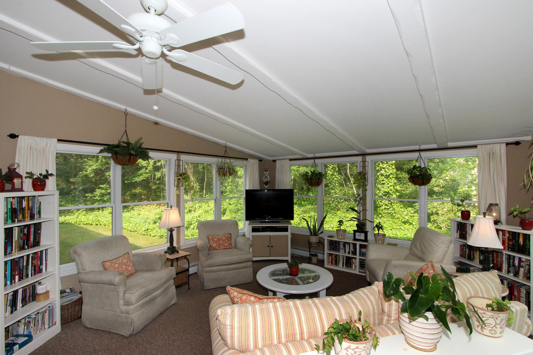 243 Midpine Road Cummaquid, MA 02675 - Photo 18 of 32 a living room with furniture a flat screen tv and a large window