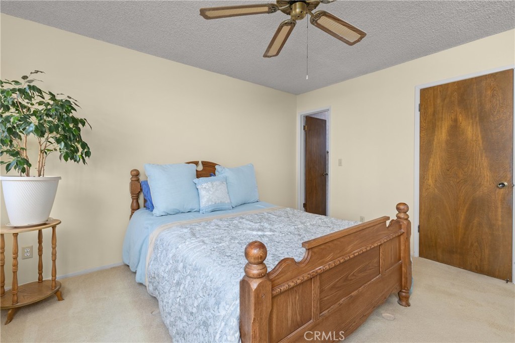 2631 Nutmeg Avenue Morro Bay, CA 93442 - Photo 14 of 39 a bedroom with a bed and a chandelier