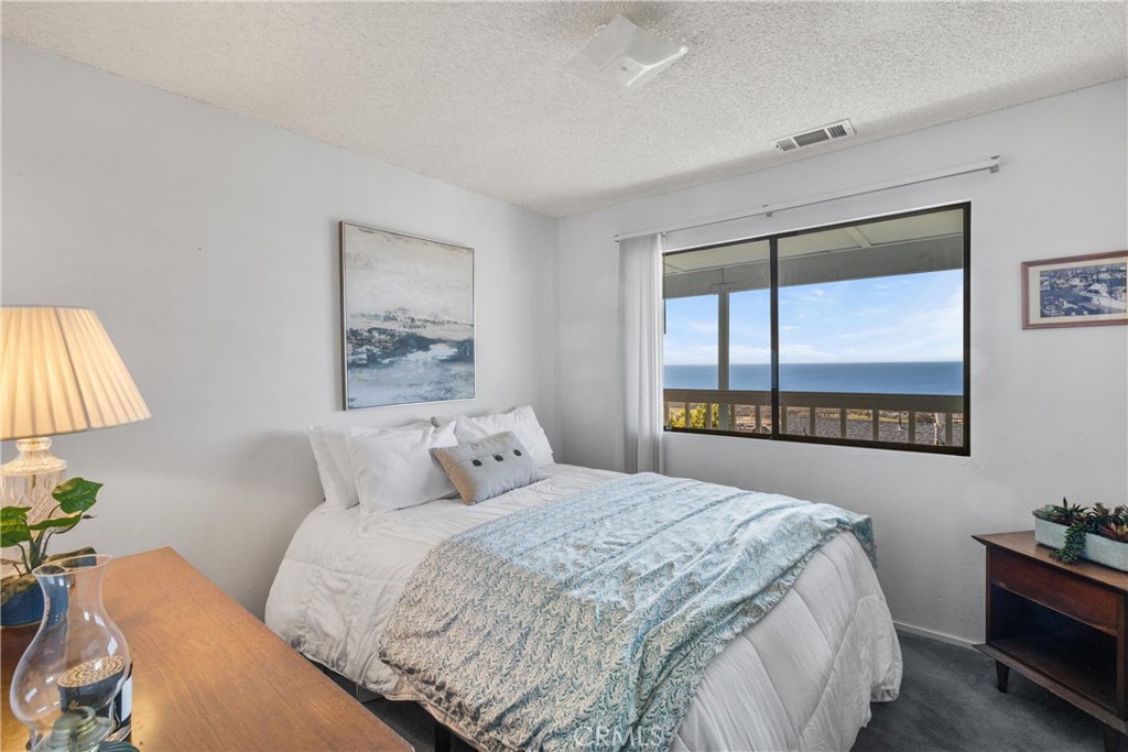 2631 Nutmeg Avenue Morro Bay, CA 93442 - Photo 17 of 39 a bedroom with a bed and a window