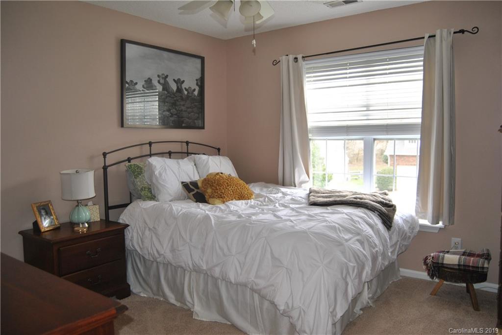 516 North Portman Lane, Unit 50 Fort Mill, SC 29708 - Photo 14 of 18 a bedroom with a bed and wooden floor