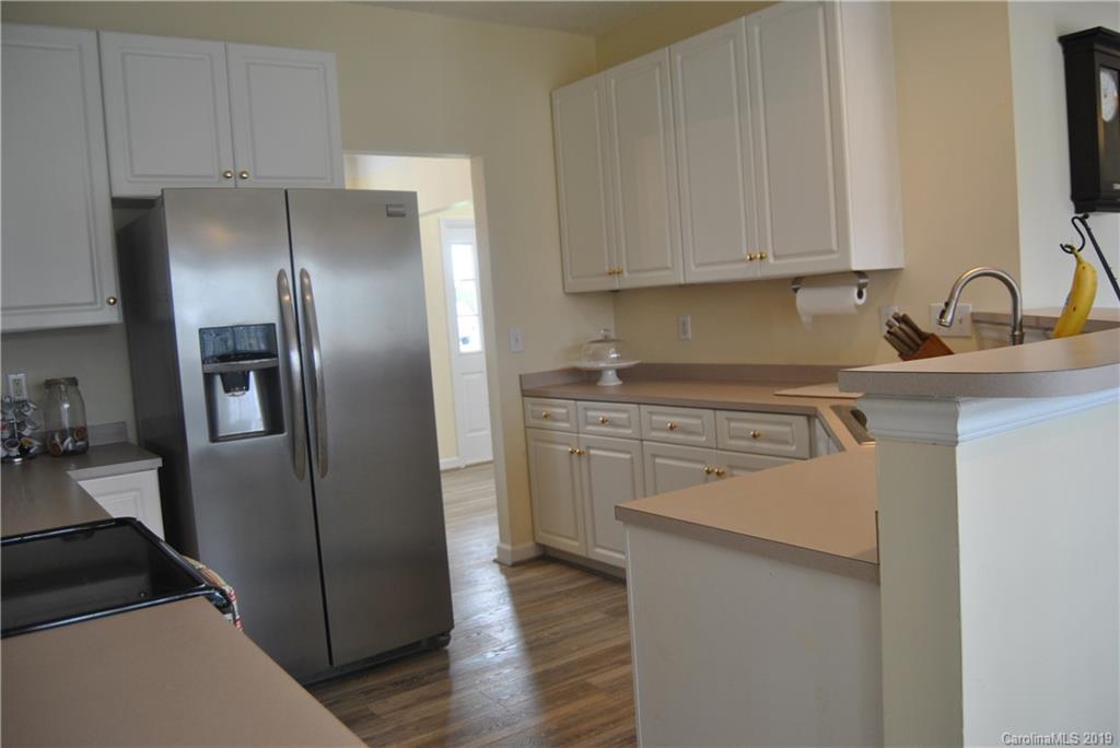 516 North Portman Lane, Unit 50 Fort Mill, SC 29708 - Photo 3 of 18 a kitchen with a refrigerator sink and cabinets