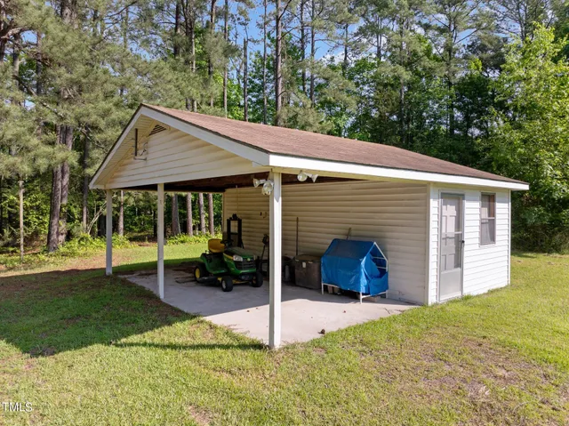 a view of a house with yard and sitting area