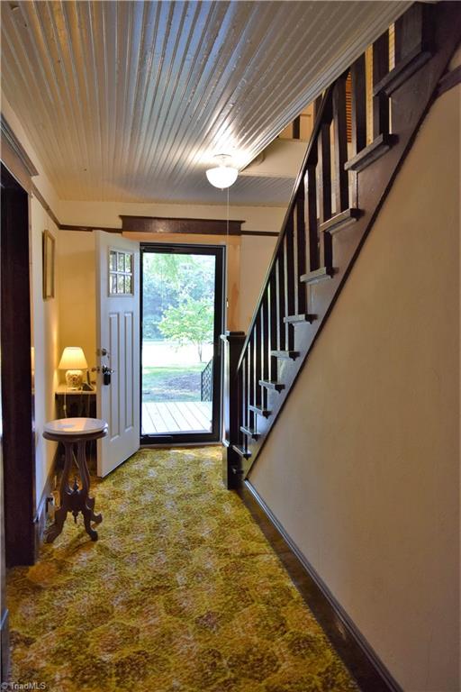 1030 Ellisboro Road Madison, NC 27025 - Photo 23 of 30 Foyer: beadboard ceiling, new front door and staircase to 2nd level. Wood floors under carpet.