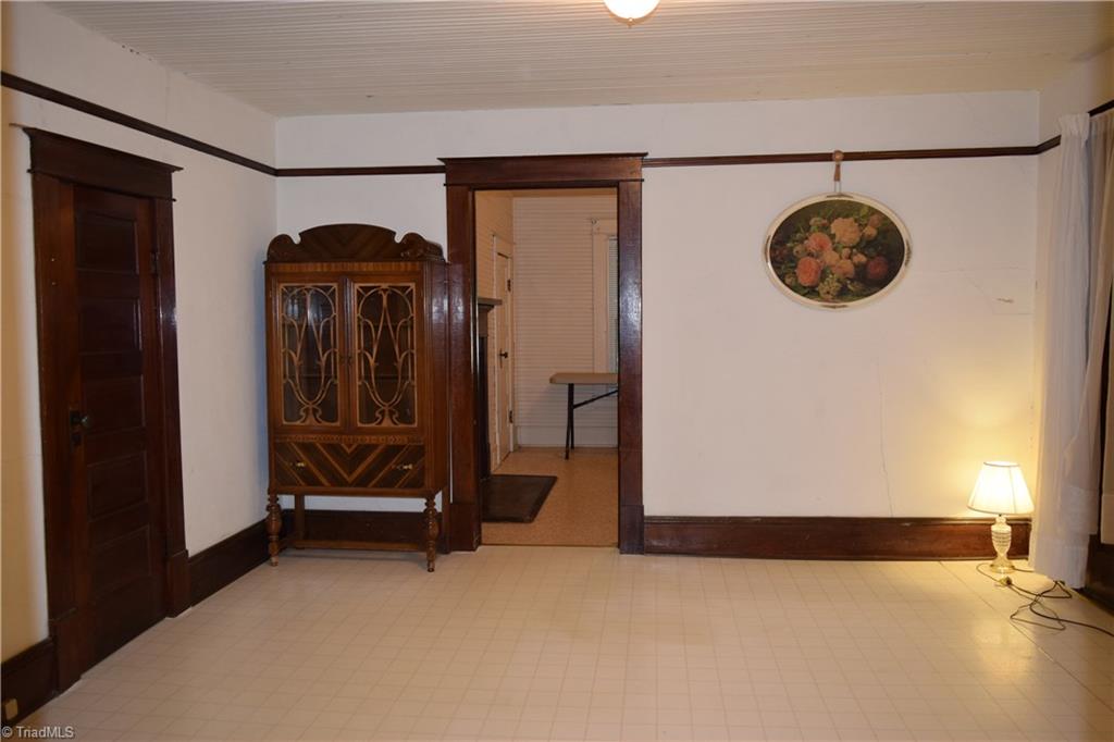 1030 Ellisboro Road Madison, NC 27025 - Photo 24 of 30 Dining Room: Additional storage under staircase. Room has 2 large windows. Note the large baseboards.