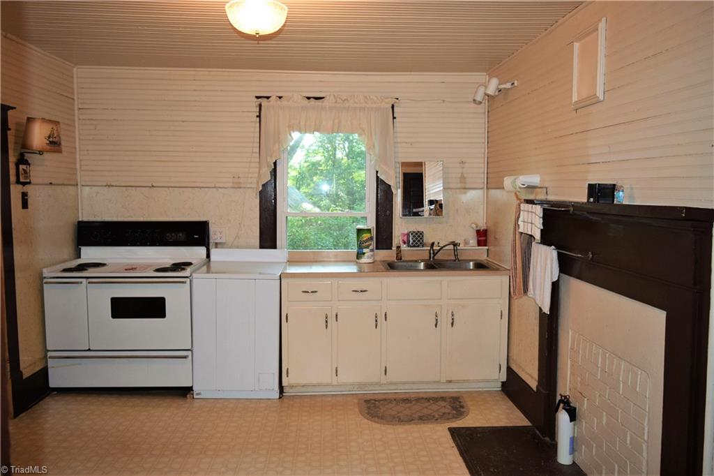 1030 Ellisboro Road Madison, NC 27025 - Photo 25 of 30 Kitchen: has large walk-in pantry with additional cabinets. New vinyl window.