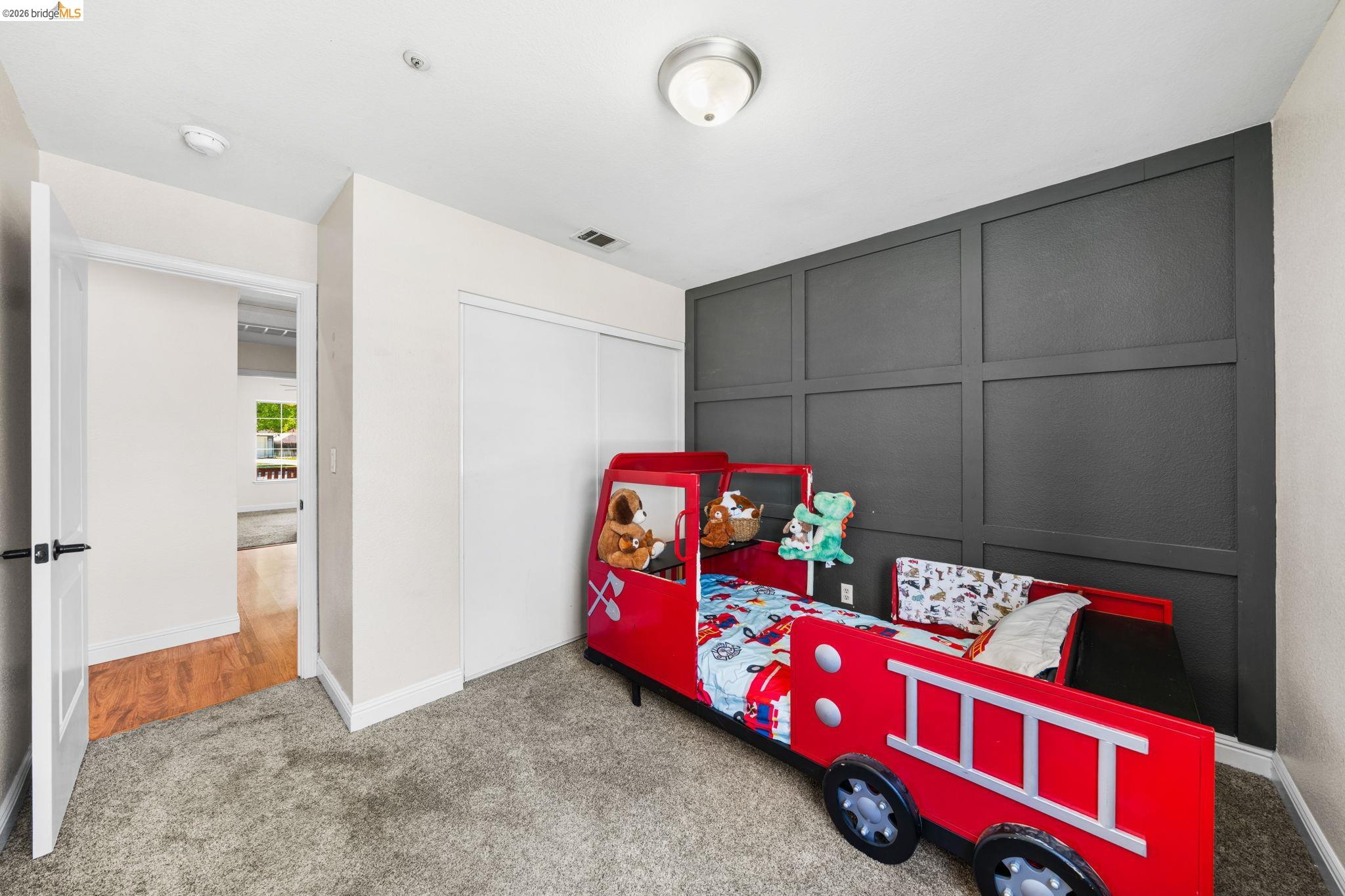 1186 El Rio Court Livermore, CA 94551 - Photo 22 of 60 Carpeted room with a dark paneled accent wall