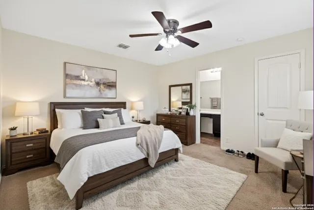 a spacious bedroom with a bed and furniture