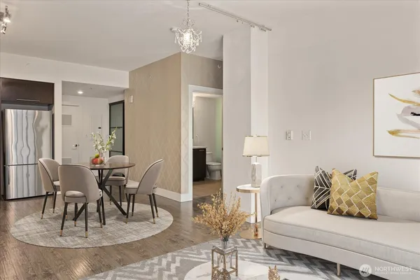 a living room with furniture and a dining table
