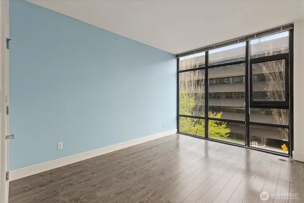 a bedroom with a bed and a large window