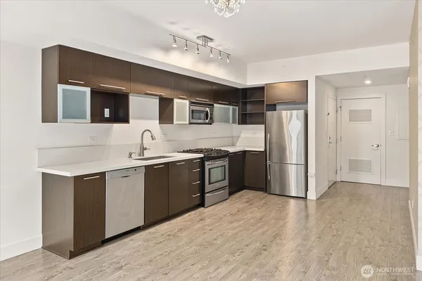 a kitchen with stainless steel appliances granite countertop a refrigerator and a sink