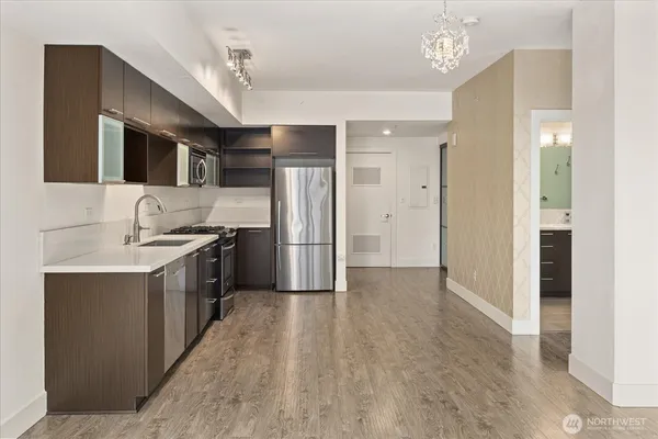 a kitchen with stainless steel appliances granite countertop a refrigerator and a sink