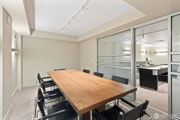 a room with furniture a sink and a mirror