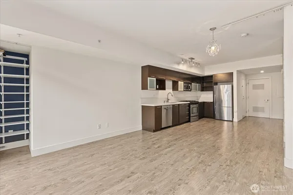 a view of a kitchen with a sink and a refrigerator