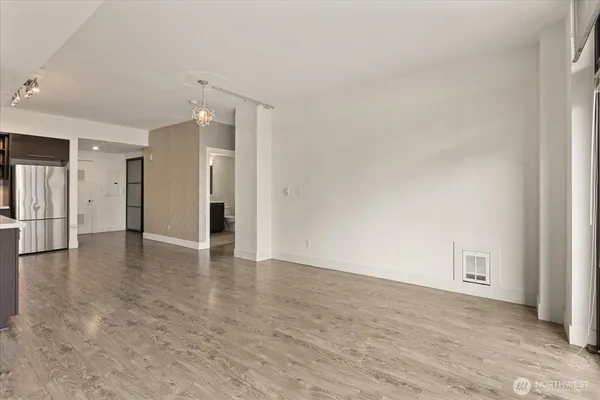 a view of an empty room and wooden floor