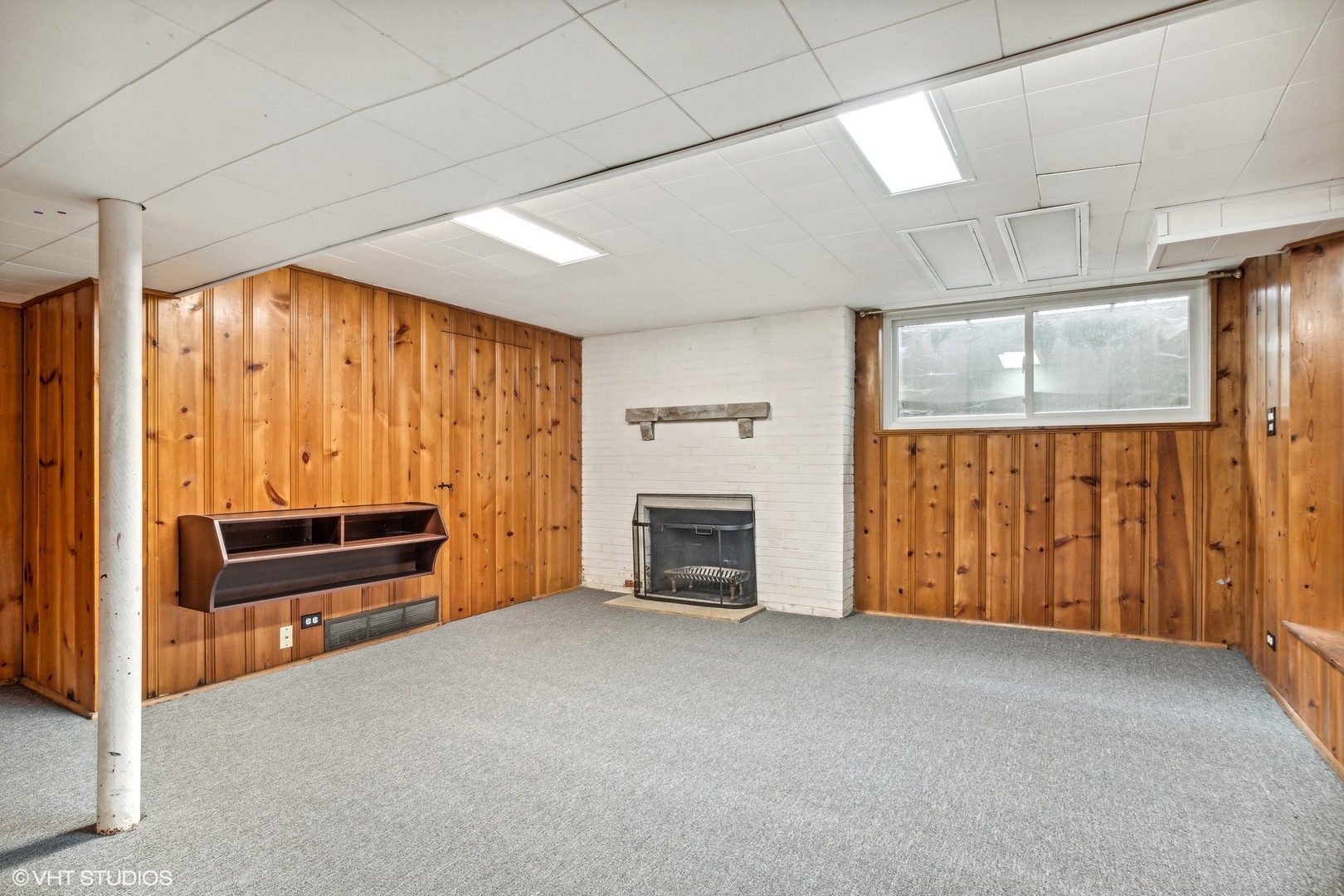 574 Braeside Road Highland Park, IL 60035 - Photo 22 of 29 a view of an empty room with a fireplace and a window