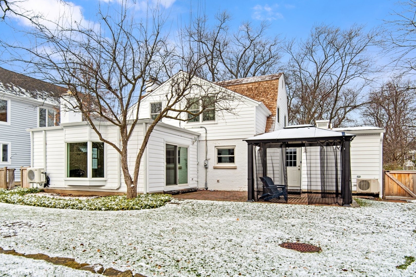 574 Braeside Road Highland Park, IL 60035 - Photo 25 of 29 a front view of a house with a yard covered in snow