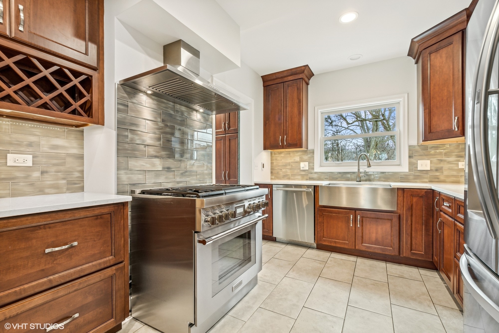 574 Braeside Road Highland Park, IL 60035 - Photo 7 of 29 a kitchen with stainless steel appliances granite countertop a stove and a sink